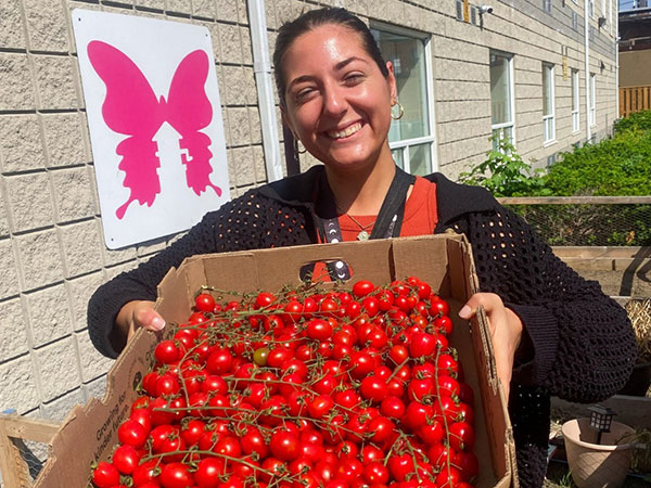 Woman smiling with cherry tomatoes